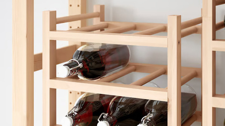 Close up of IKEA HUTTEN wine rack with bottles laying on it
