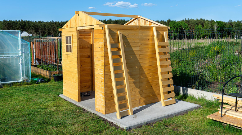 A garden shed on a concrete base under construction