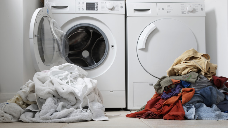 Dirty clothes in front of washing machine