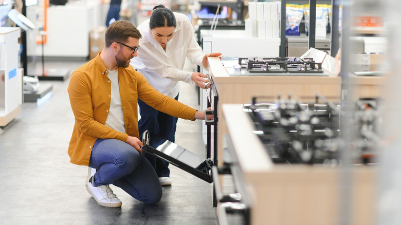 A couple shopping for stoves