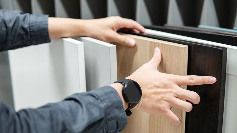 Close-up of a man browsing kitchen countertop samples