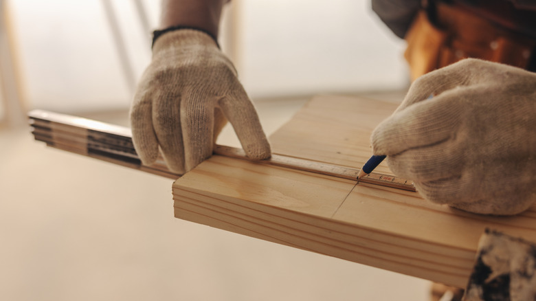 A woodworker cutting pieces of scrap wood.