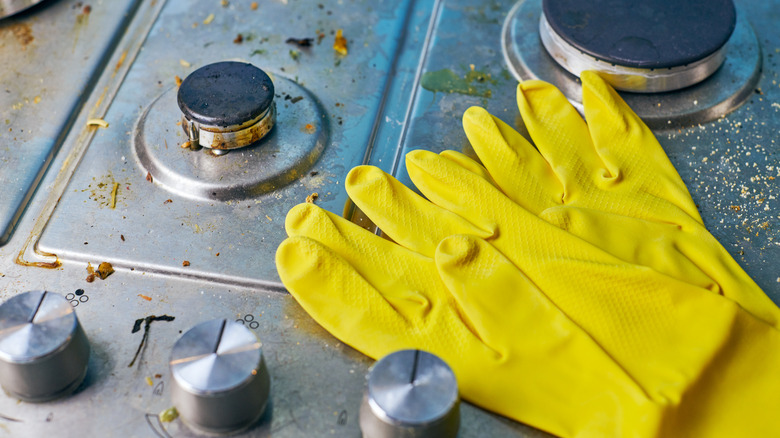 gloves on greasy gas stovetop