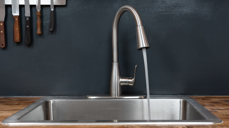 Woman cleaning a bathroom sink