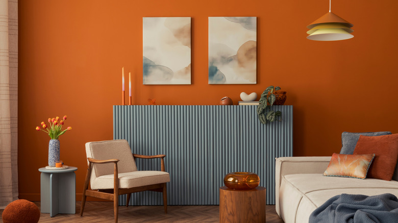 Living room with orange accent wall and eclectic décor