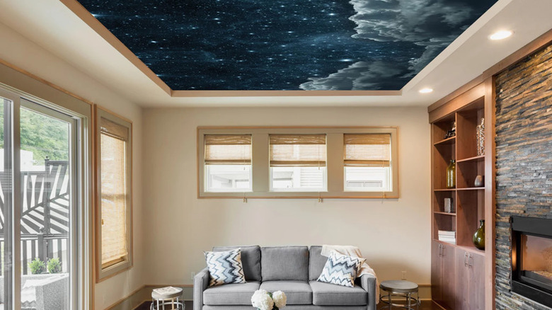 A living room with a night sky ceiling mural.