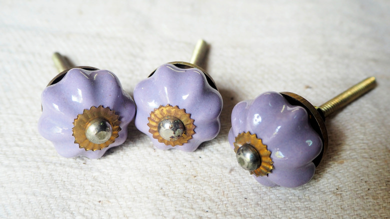 Light purple ceramic cabinet pulls.