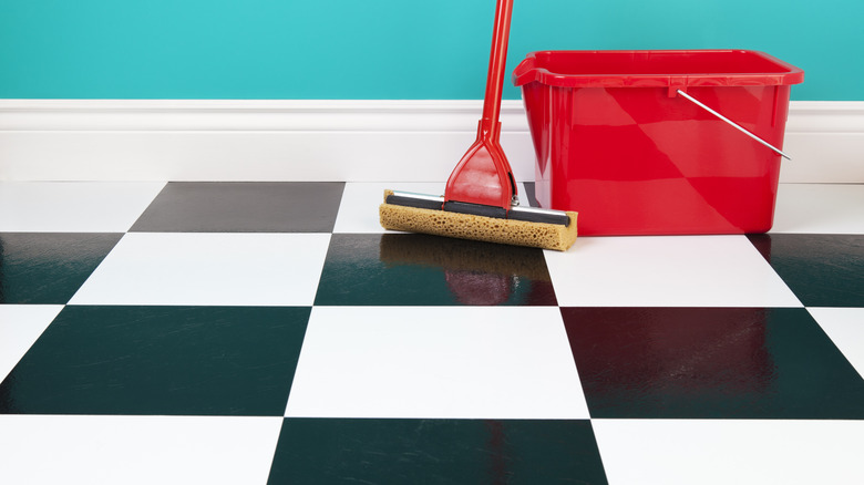 cleaning implements checkered linoleum floor