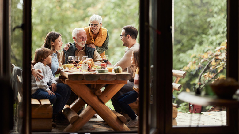 A family eating on their porch outside