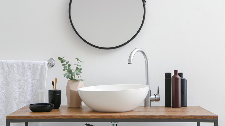 bathroom sink with circle mirror