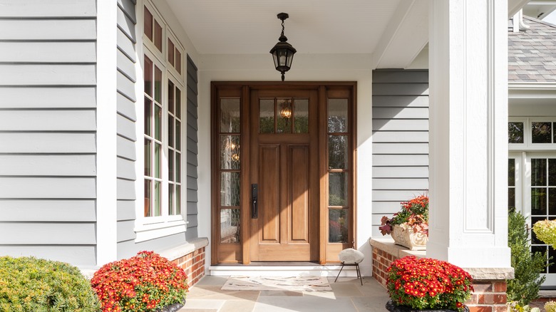 A brown wooden front door that isn't accessorized