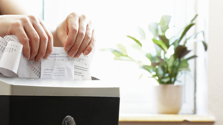 Woman shredding receipts