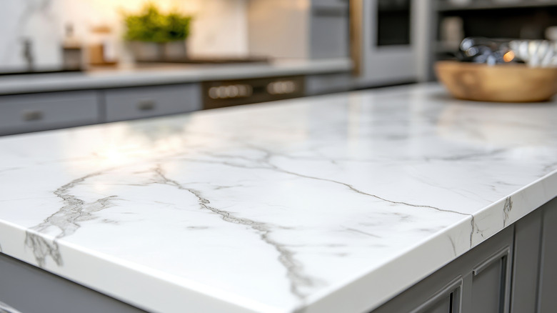 A white stone kitchen countertop with grey veining