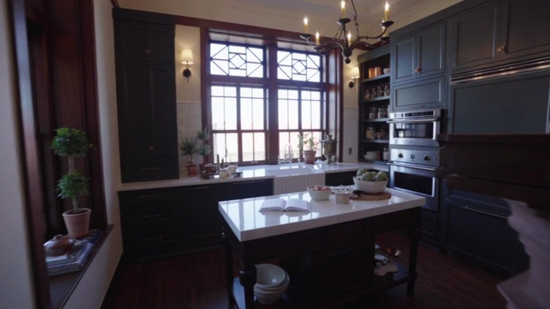Dark green cabinets with white walls