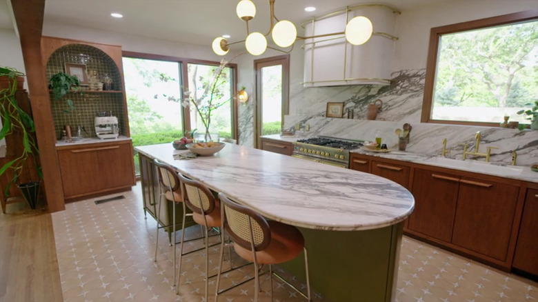Moss green island with white marble counters and backsplash