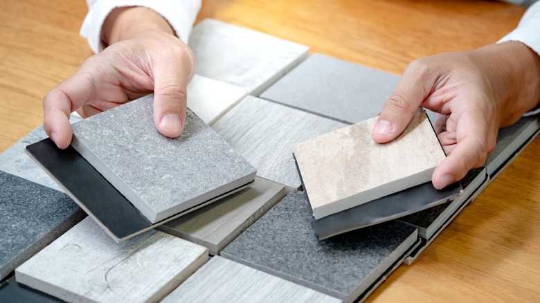 person handling small stone countertop samples