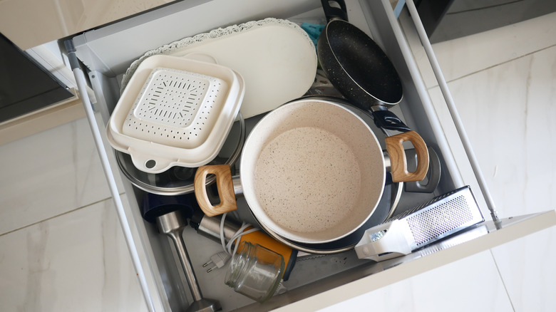 A disorganized kitchen drawer