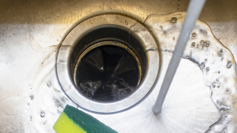 Closeup of a garbage disposal the water running over it