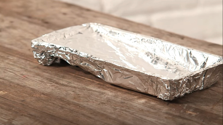 A paint tray covered in aluminum foil