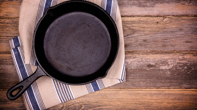 cast iron pan resting on a linen kitchen towel
