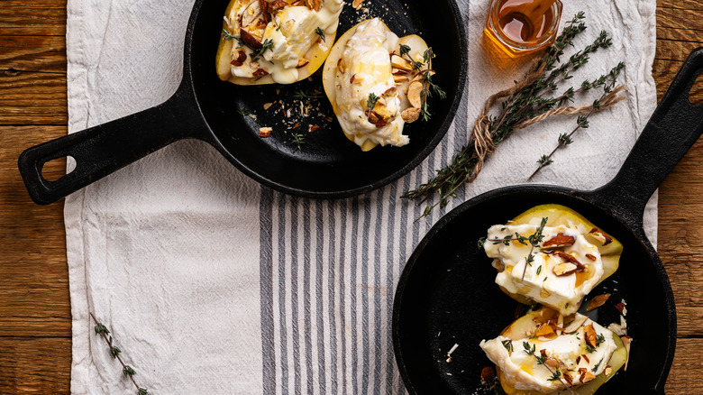 cast iron pans with stuffed pears in them