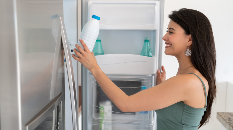 a woman grabbing milk
