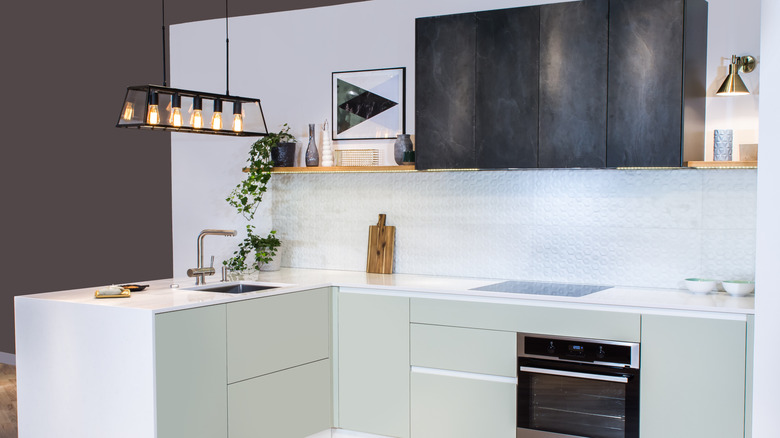 Kitchen peninsula with clean counter space and an overhead light fixture
