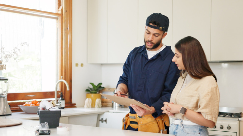 Contractor discussing plans for a kitchen island with homeowner