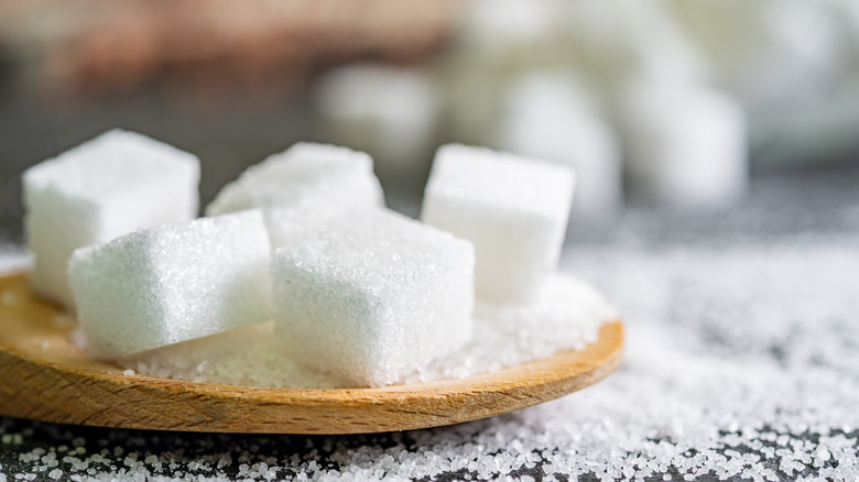 sugar cubes on wooden spoon