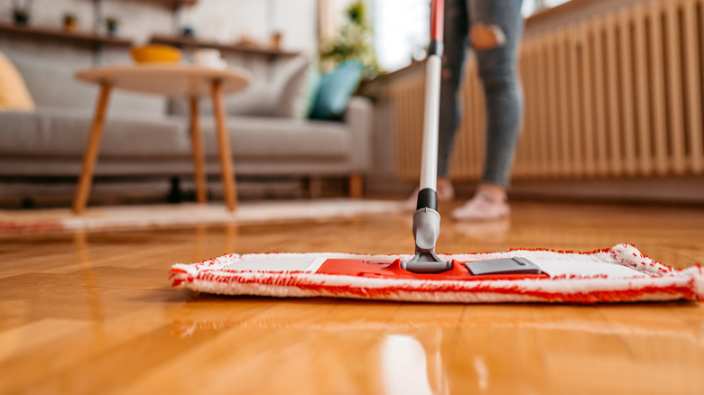 woman mopping wooden floors