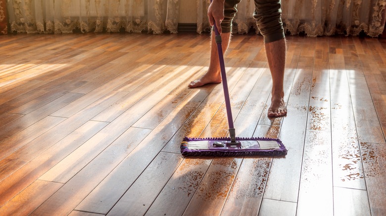 Man mopping a wood floor