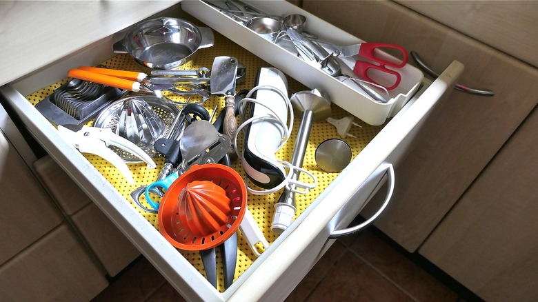 Person looking through gadgets drawer