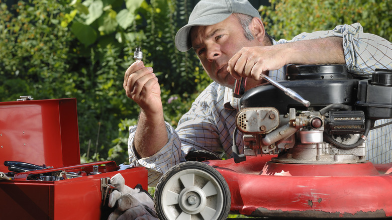 professional fixes lawn mower