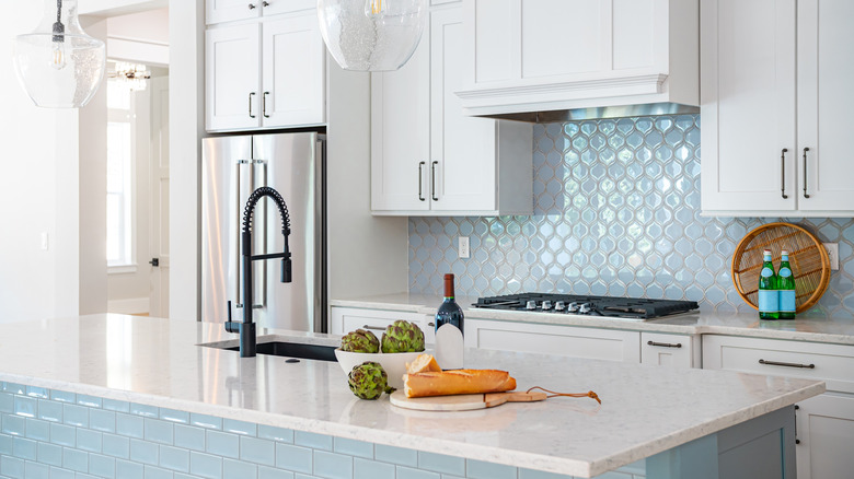 Luxurious modern kitchen with white cabinets and tile backsplash