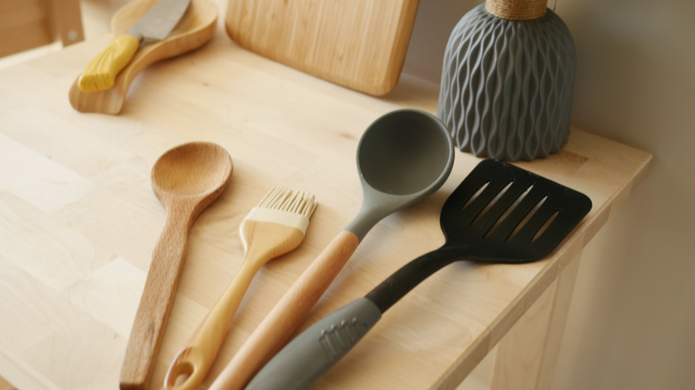 A set of cooking utensils on a wooden countertop