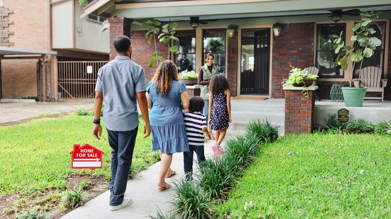 Family walking into a house for sale