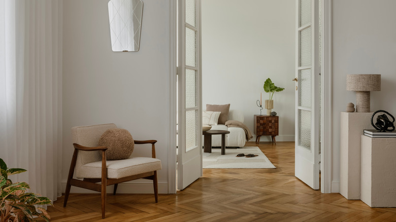 mid-century modern rooms with white walls, french doors, and herringbone floors