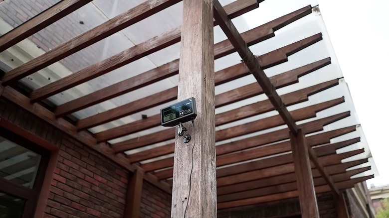 Photon Matrix laser mounted on wooden post outdoors