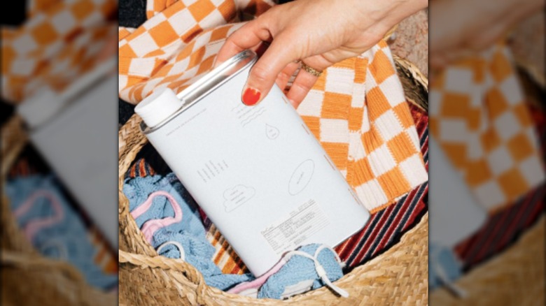 Placing DedCool Laundry Detergent in a hamper