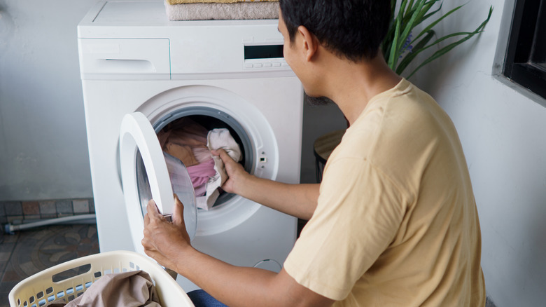 person loading dryer
