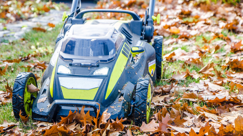 Close up of lawn mower mulching leaves