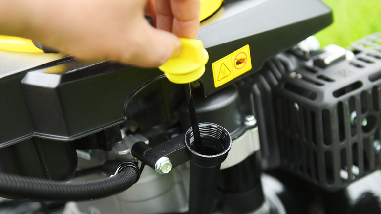 Checking a lawnmower's engine oil dipstick