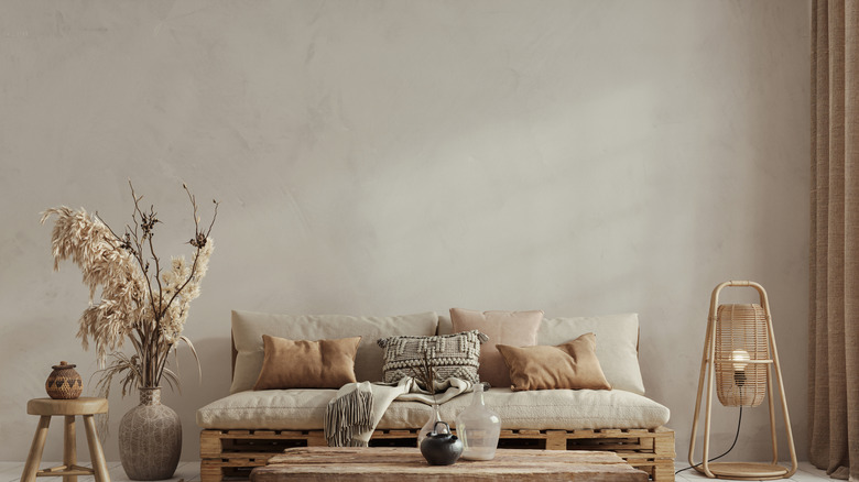 A living room space with a limewash wall and furniture with neutral tones