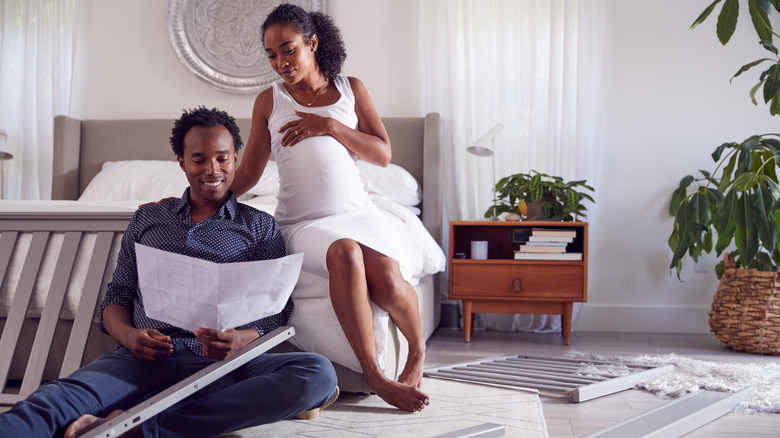 Couple putting crib together