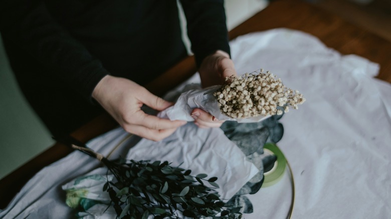 Person making wreath