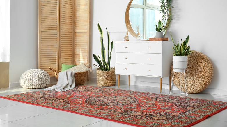 A cozy neutral living room with a vintage carpet