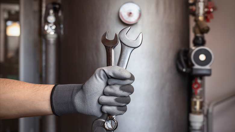 A worker installing a heat pump water heater
