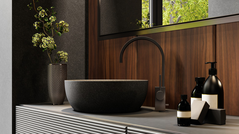 Bathroom counter with black soap dispensers and sink