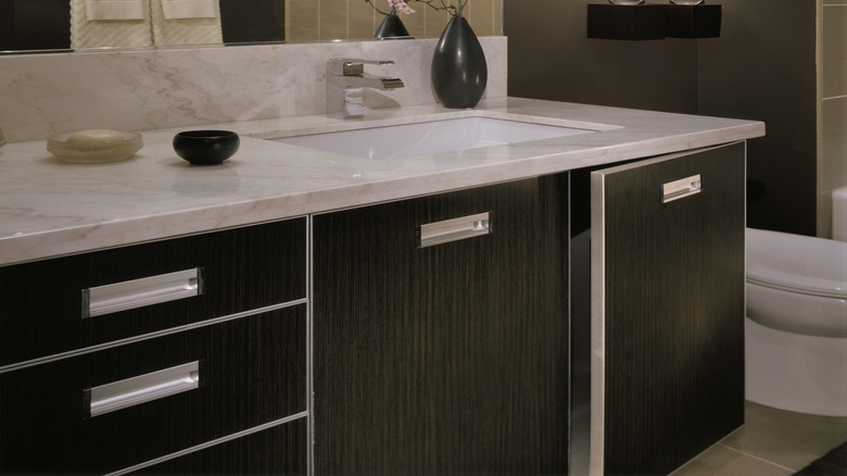 Black bathroom with white countertops