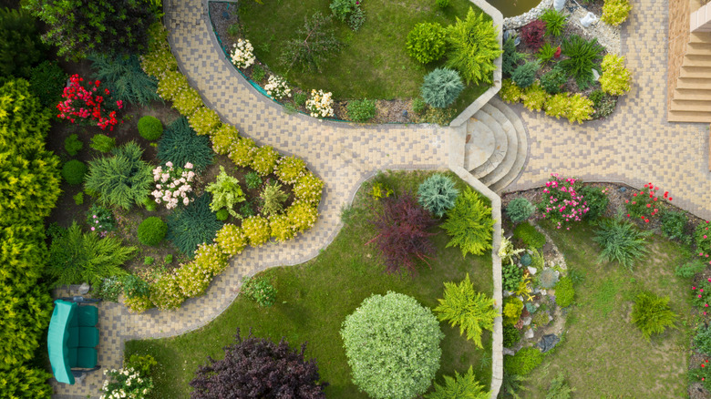 Garden with walkways and green grass. Photo taken from above drone.